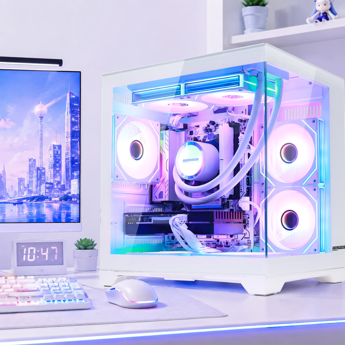Hoengager Panorama Series Gaming PC white desktop computer tower with Ryzen 8700F Geforce RTX 3060 12 GB GPU, a transparent side panel, showcasing a custom liquid CPU cooler with glowing RGB fans and tubing. The PC is set on a desk next to a keyboard, mouse, and monitor on a light gray surface.
